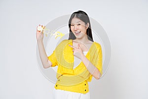 Young asian woman in hand holds HAPPY glasses isolate white background