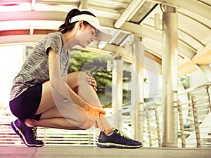 Young asian woman has legs pain, after exercise training. Lifestyle and healthy concept.