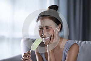 Young Asian woman have sensitive teeth with ice-cream