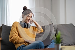 Young asian woman having conversation chatting while using laptop at house. Work at home, Video conference, Online