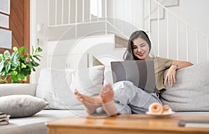 Young asian woman having conversation chatting while using laptop at house. Work at home, Video conference, Online