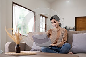 Young asian woman having conversation chatting while using laptop at house. Work at home, Video conference, Online