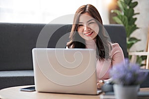 Young asian woman having conversation chatting while using laptop at house. Work at home, Video conference, Online