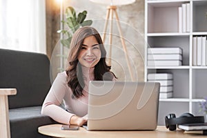 Young asian woman having conversation chatting while using laptop at house. Work at home, Video conference, Online