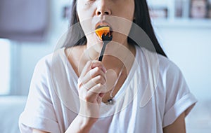 Young asian woman having fresh fruits papaya slices,Concept healthy food