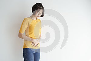 Young asian woman having painful stomachache on white background.Chronic gastritis