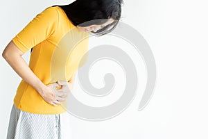 Young asian woman having painful stomachache  white background.Chronic gastritis. Abdomen bloating concept