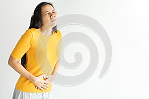 Young asian woman having painful stomachache on white background.Chronic gastritis. Abdomen bloating concept
