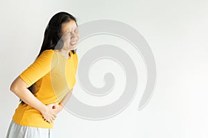 Young asian woman having painful stomachache on white background.Chronic gastritis. Abdomen bloating concept photo