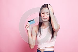 Young Asian woman headache with a blank card.