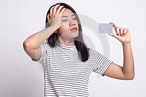 Young Asian woman headache with a blank card