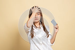 Young Asian woman headache with a blank card