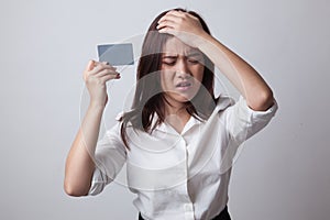 Young Asian woman headache with a blank card.