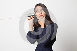 Young Asian woman hearing with tin can phone and thinking