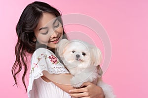 Young Asian woman with her dog chihuahua hug and feeling happy shoot in isolated on pink background.