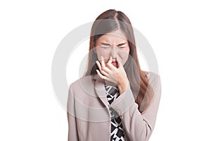 Young Asian woman holding her nose because of a bad smell.