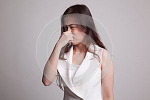 Young Asian woman holding her nose because of a bad smell.