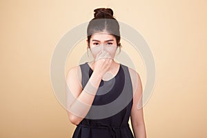 Young Asian woman holding her nose because of a bad smell.