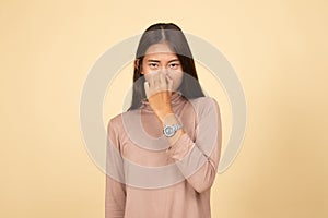 Young Asian woman  holding her nose because of a bad smell