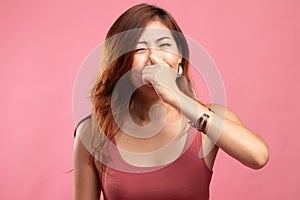 Young Asian woman  holding her nose because of a bad smell
