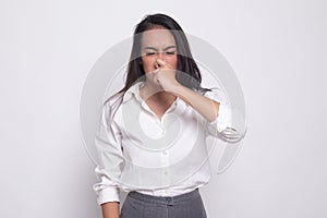 Young Asian woman  holding her nose because of a bad smell