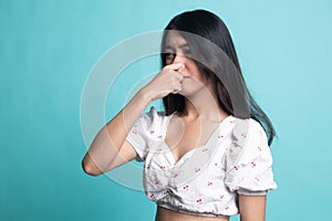 Young Asian woman  holding her nose because of a bad smell