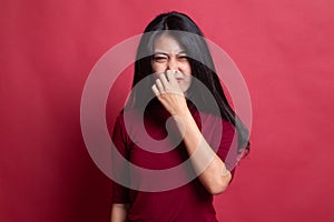 Young Asian woman  holding her nose because of a bad smell