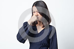 Young Asian woman  holding her nose because of a bad smell
