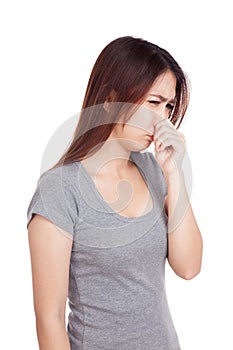 Young Asian woman holding her nose because of a bad smell