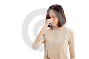 Young Asian woman holding her nose because of a bad smell