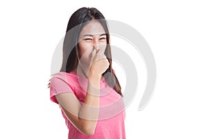 Young Asian woman holding her nose because of a bad smell..