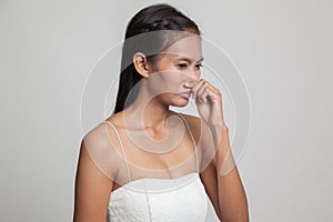 Young Asian woman holding her nose because of a bad smell.