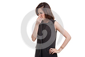 Young Asian woman holding her nose because of a bad smell.