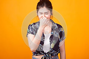 Young Asian woman holding her nose because of a bad smell in tr