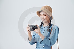 Young Asian woman holding vintage camera isolated on white background