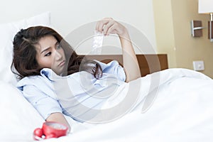 Young Asian woman insomnia taking sleeping pills