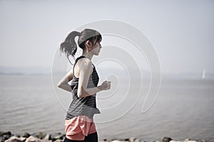 Young asian woman jogging outdoors