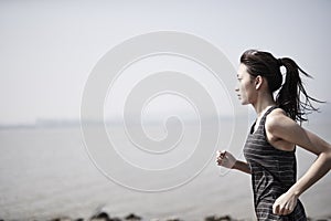 Young asian woman jogging outdoors