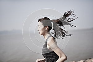 Young asian woman jogging outdoors