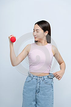 Young asian woman lifting dumbbells