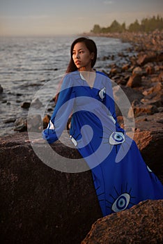 Young asian woman in long blue dress