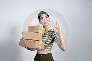 Young asian woman moving to a new home cheerful and confident showing ok gesture