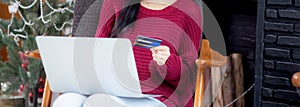 Young asian woman online shopping in Christmas with credit card on laptop computer, female buying and payment.