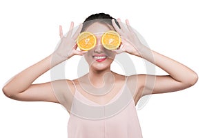Young asian woman with orange in her hands isolated on white background