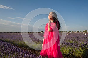 Young Asian woman outdoors at lavender flowers field - happy and beautiful Japanese girl in sweet Summer magenta dress enjoying