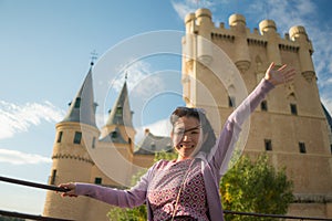 Young Asian woman outdoors lifestyle portrait -  happy and beautiful Japanese girl enjoying  fairytale style castle from viewpoint