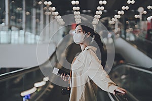 Young asian woman passenger in airport terminal or modern train station