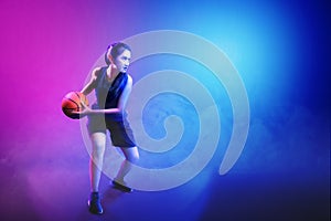 Young asian woman playing basketball