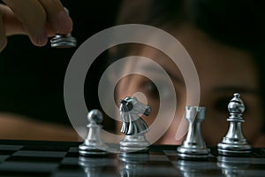 Young asian woman is playing chess