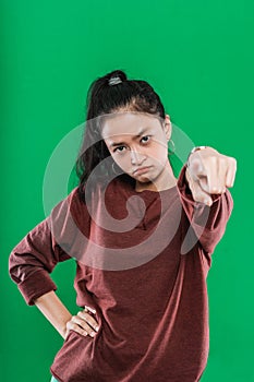 young Asian woman pointing at the camera while expression pissed off the face